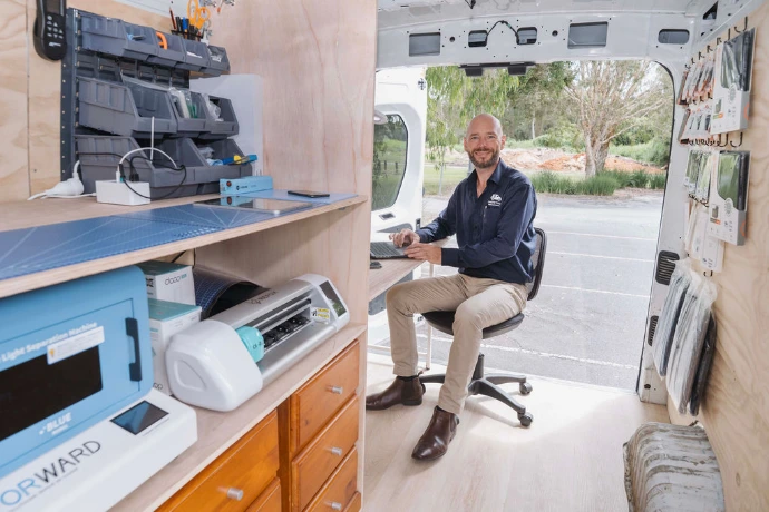 Technician working on laptop repairs and providing IT support